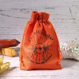 K&ouml;nnte beinhalten: Orangefarbener Kordelbeutel mit dem Aufdruck "Crystal Gifts Hut Natural Healing Crystals".