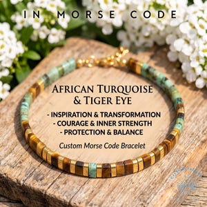May include: A beaded bracelet featuring alternating segments of African turquoise and tiger eye stone beads with gold-tone spacers. The text reads: IN MORSE CODE, AFRICAN TURQUOISE & TIGER EYE, INSPIRATION & TRANSFORMATION, COURAGE & INNER STRENGTH, PROTECTION & BALANCE, Custom Morse Code Bracelet.