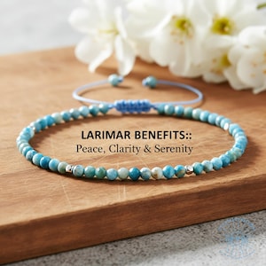 May include: A blue beaded bracelet with silver accents, displayed on a wooden surface. The bracelet is made of small, round, blue and white beads. Text on the image reads "LARIMAR BENEFITS:: Peace, Clarity & Serenity."