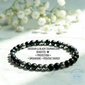 May include: A black obsidian and black tourmaline beaded bracelet. The bracelet features a mix of matte black and silver beads. Text on the image reads: Obsidian & Black Tourmaline Benefits: Protection, Grounding, Positive Energy.