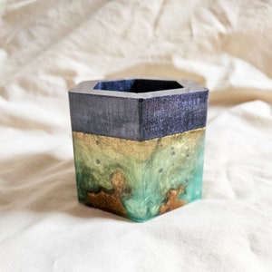 Multicolor epoxy resin 3 inch plant pot with purple, green, and bronze accents.Made from left over epoxy colors over multiple sessions