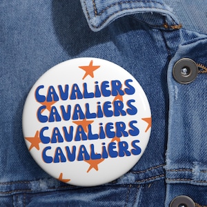 May include: A white button with the word "CAVALIERS" repeated four times in blue, with a retro font style. The button is decorated with orange star shapes.