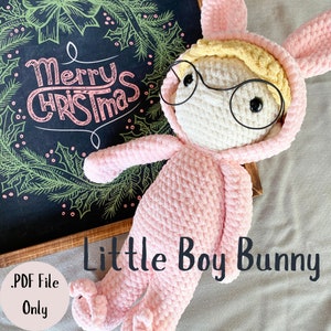 May include: A pink crocheted bunny wearing glasses with a white face and yellow hair. The bunny is lying on a light gray surface. The text "Little Boy Bunny" is written in black below the bunny. The text ".PDF File Only" is written in black in the lower left corner of the image.