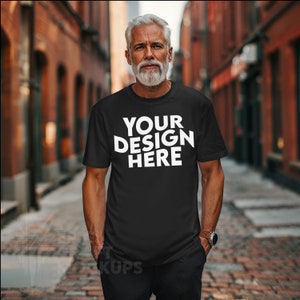 Könnte beinhalten: Ein schwarzes T-Shirt mit dem Text "YOUR DESIGN HERE" in weiß auf der Vorderseite.