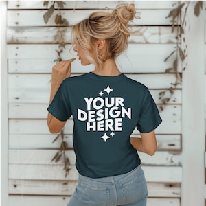 May include: A dark blue t-shirt with white text that says "YOUR DESIGN HERE" and two small white stars on the back.