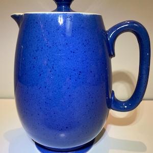 May include: A blue ceramic coffee pot with a lid and a speckled glaze.