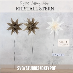 Könnte beinhalten: Digitale Schneidedateien für KRISTALL STERN mit zwei braunen und einem weißen, mehrzackigen Papierstern auf dünnen schwarzen Stielen. Enthält ein Video-Tutorial-Etikett und einen kleinen Streifen mit Sternsymbolen. Formate: SVG, STUDIO3, DXF, PDF.