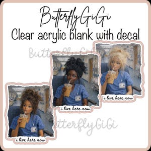 May include: A clear acrylic blank with a decal featuring three illustrations of individuals in blue medical scrubs holding iced coffee cups. Each illustration includes the text "i live here now" at the bottom. The brand name "Butterfly GiGi" is visible.
