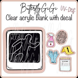 May include: Clear acrylic blank with decal featuring a polaroid-style design with scribbled text, alongside crime scene-themed stickers including a spray bottle, fingerprint, gloves, evidence marker, and evidence bag.