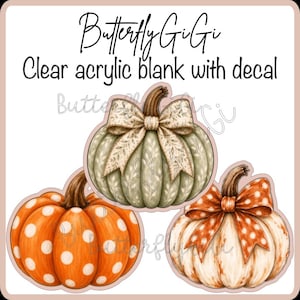 May include: A clear acrylic blank with a decal featuring three pumpkins. One pumpkin is orange with white polka dots, one is sage green with a patterned bow, and one is white with an orange polka dot bow. Text reads Butterfly GiGi.