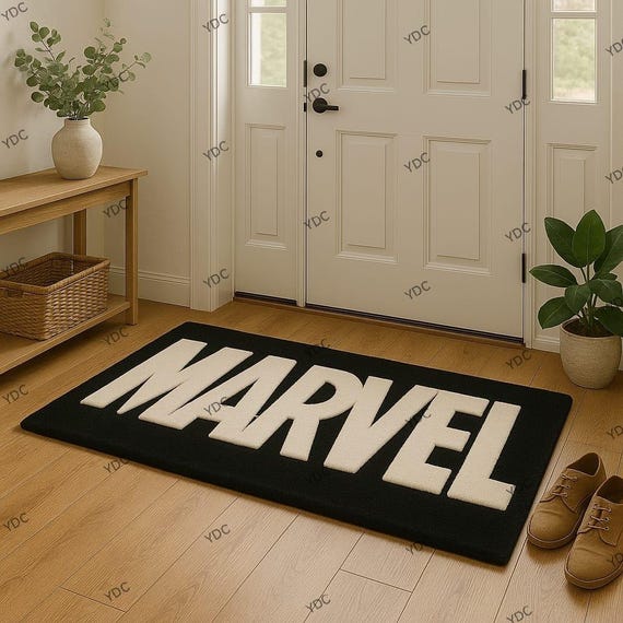 Marvel Hand Tufted Rug in Black & White Entrance Carpet with Bold Logo Design