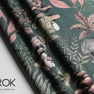 May include: Dark teal fabric with a detailed forest print featuring mushrooms, ferns, and woodland creatures in shades of brown, pink, and green. The fabric has a textured appearance and is suitable for various craft projects.