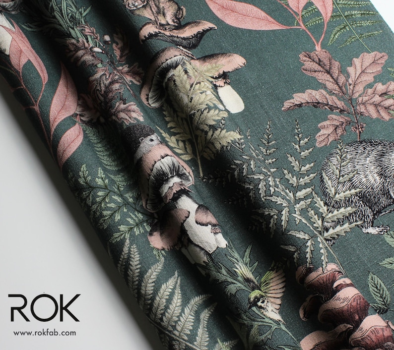 May include: Dark teal fabric with a detailed forest print featuring mushrooms, ferns, and woodland creatures in shades of brown, pink, and green. The fabric has a textured appearance and is suitable for various craft projects.