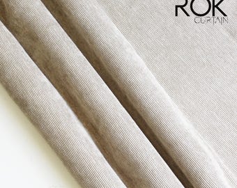 May include: Beige corduroy fabric with diagonal lines, draped in soft folds. The fabric has a textured appearance, with the text "ROK CURTAIN" in the upper right corner.