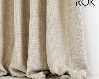 May include: A close-up of a beige linen curtain with a subtle textured pattern. The curtain is gathered at the bottom, creating soft folds. The text "ROK CURTAIN" is visible in the top right corner of the image.
