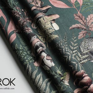 May include: Dark teal fabric with a detailed forest print featuring mushrooms, ferns, and woodland creatures in shades of brown, pink, and green. The fabric has a textured appearance and is suitable for various craft projects.