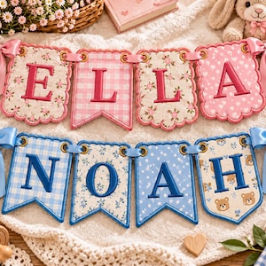 May include: Two fabric banner sets featuring embroidered letters. The top banner spells ELLA in pink with floral, gingham, and heart patterns, accented by pink satin bows. The bottom banner spells NOAH in blue with gingham, floral, and bear patterns, accented by blue satin bows.
