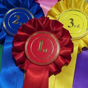 May include: Five colourful satin ribbons with gold trim and numbers 1st, 2nd, 3rd, 4th, and 5th printed on the centre of each ribbon.
