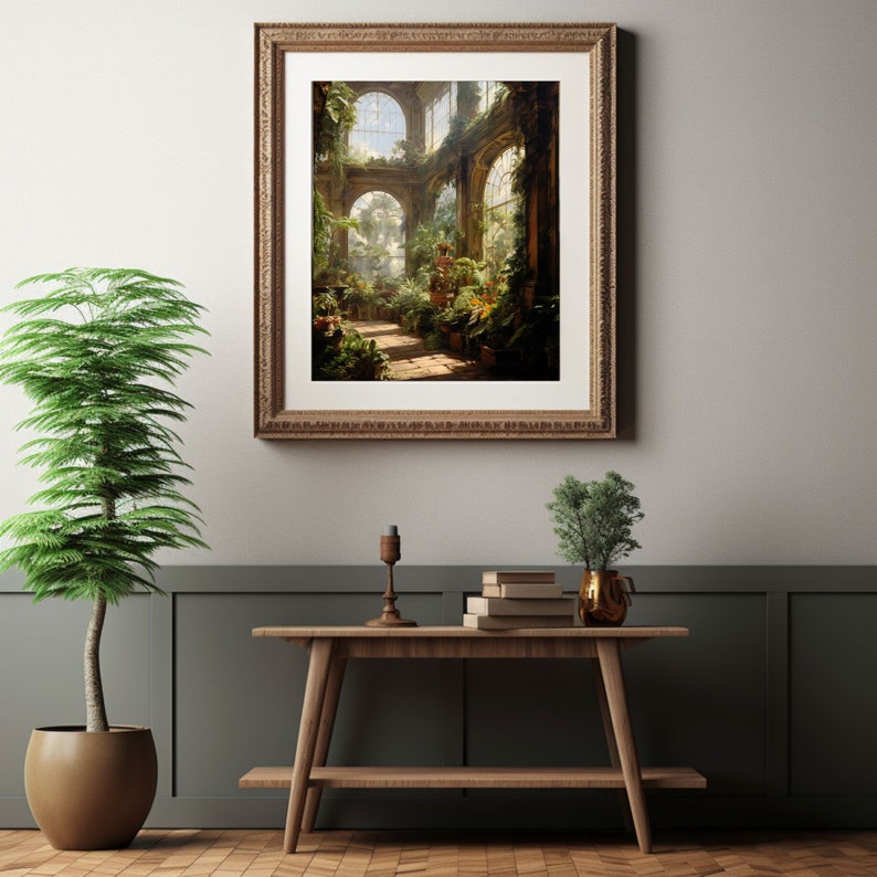 May include: A framed print depicting a sunlit conservatory filled with lush greenery and architectural details. The artwork is displayed above a wooden console table with decorative items and a potted plant, creating a serene interior scene.