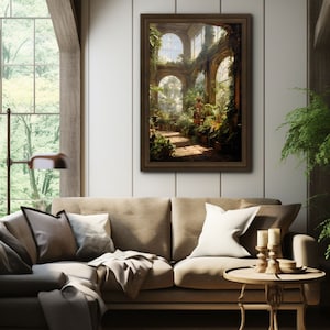 May include: A framed art print depicts a sunlit greenhouse interior with arched windows and lush greenery. The artwork, in warm tones, hangs above a beige sofa with pillows, complemented by a wooden side table and candles, creating a cozy living room setting.