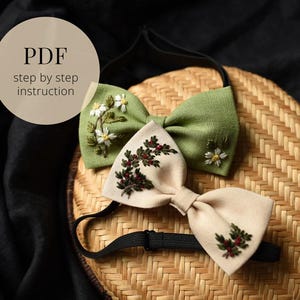 May include: Two embroidered bow ties. One is green with white flowers, the other is beige with red berries. The bow ties are on a woven surface with the text "PDF step by step instruction" in a circle.