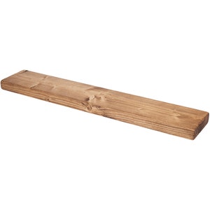 Handcrafted rustic floating shelf made of reclaimed wood. Features a natural finish, highlighting wood grain & knots. Perfect for farmhouse or vintage decor. Ideal for displaying books, plants & decor items. Eco-friendly & sustainable choice for home