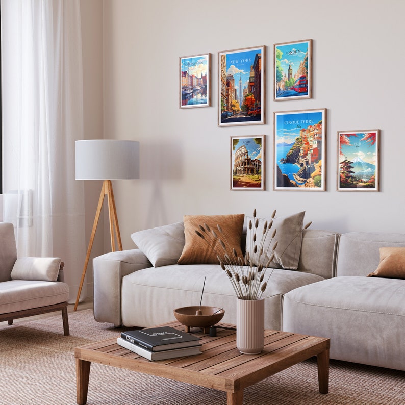 May include: A living room interior with a white couch and a wooden coffee table. The wall is decorated with six framed travel posters featuring various cities, including New York, London, Rome, and Cinque Terre.