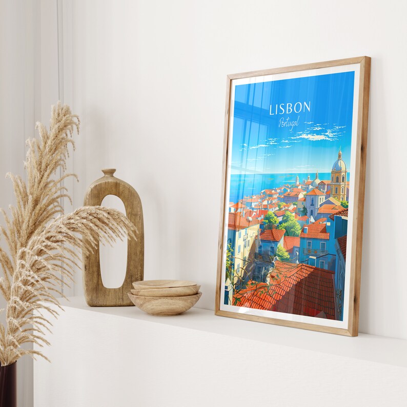 May include: A vintage travel poster with a colorful illustration of Lisbon, Portugal. The poster features a cityscape with red-tiled roofs, a blue ocean, and a white church with a dome. The text "LISBON Portugal" is printed in white on a blue background.