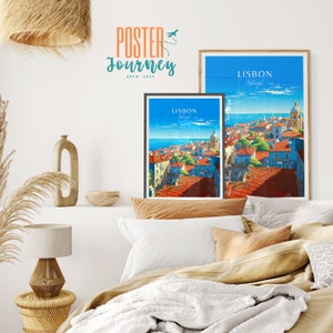 May include: Two framed posters with a cityscape view of Lisbon, Portugal. The posters are hanging on a white wall above a bed with a white blanket and brown pillows.