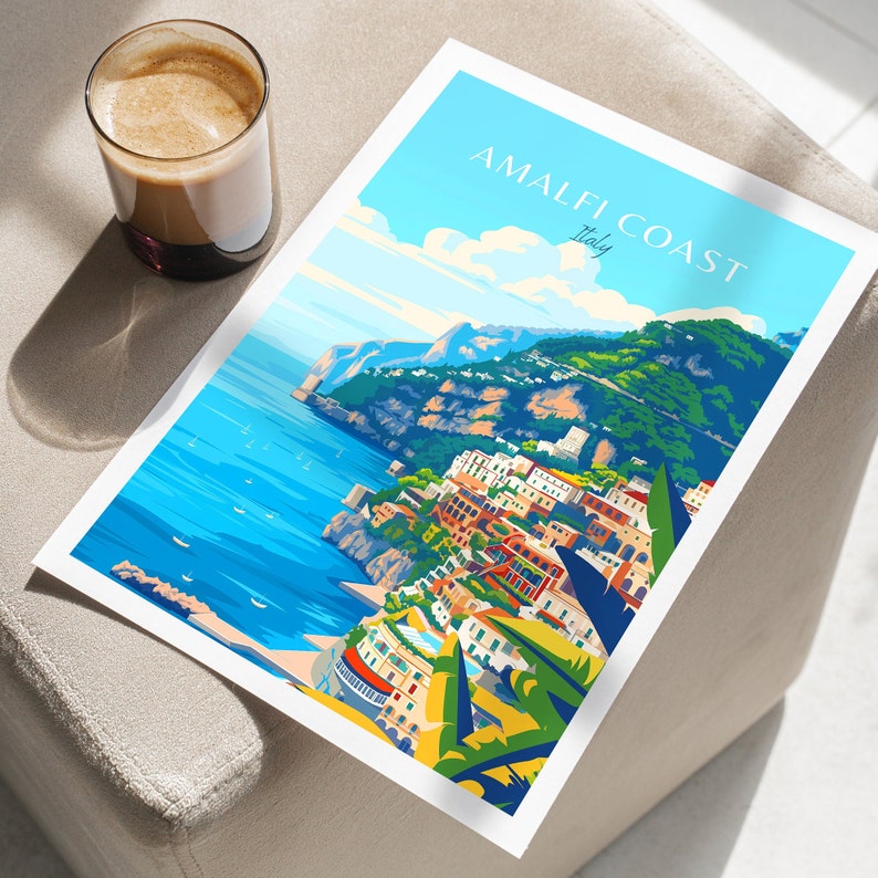 May include: A colorful illustration of the Amalfi Coast in Italy. The image shows a coastal town with colorful buildings, a blue sea, and green hills. The text "Amalfi Coast Italy" is printed in white on a blue background.