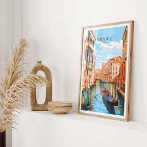 Puede incluir: Una impresi&oacute;n enmarcada de una pintura colorida que representa una g&oacute;ndola en un canal de Venecia, Italia. El texto "VENICE Italy" est&aacute; en la esquina superior derecha de la impresi&oacute;n.