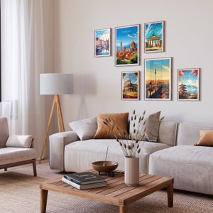 May include: A living room with a white couch and a wooden coffee table. There are six framed posters on the wall, each featuring a different city skyline. The posters are in a variety of colors and styles.