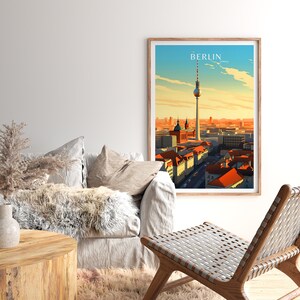 May include: A framed print of a cityscape with the Berlin Television Tower in the center. The print has a vintage travel poster aesthetic with the word "BERLIN" in a bold font at the top.