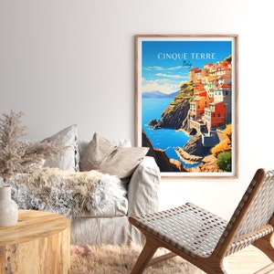 May include: A vintage travel poster featuring a colorful illustration of the Cinque Terre region of Italy. The poster features a seaside town with colorful buildings built into the cliffs. The text on the poster reads "Cinque Terre, Italy".