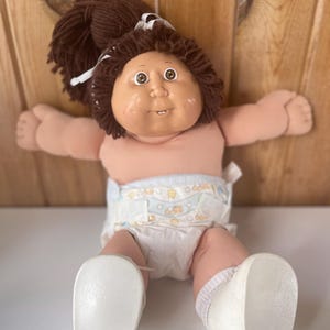 2010 Cabbage Patch Kids Doll – Brown Yarn Hair, Brown Eyes, Soft Body Baby Doll with Diaper & Shoes – Classic Xavier Roberts Style