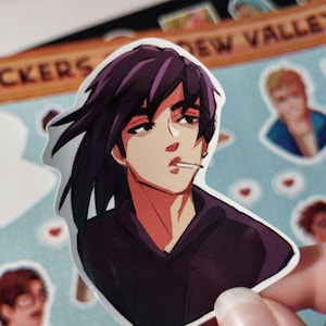 May include: A sticker of a cartoon character with purple hair, wearing a black hoodie and holding a cigarette. The character has a serious expression on their face.