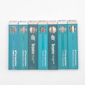 May include: A set of three ceramic mugs with a speckled, matte finish. The mugs are in shades of cream, light brown, and dark brown. Each mug has a simple, minimalist design, perfect for coffee or tea.