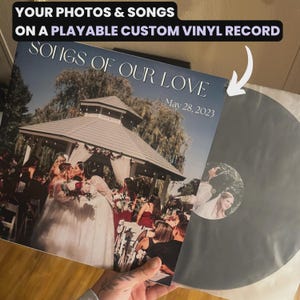 May include: A custom vinyl record with a wedding photo on the cover. The record is in a protective sleeve. The cover reads "SONGS OF OUR LOVE" and "May 28, 2023". The text "YOUR PHOTOS & SONGS ON A PLAYABLE CUSTOM VINYL RECORD" is at the top.