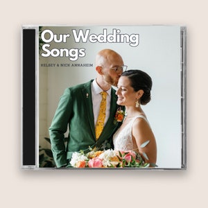 May include: A CD case with a photo of a couple in a wedding setting. The text on the case reads "Our Wedding Songs" and "Kelsey & Nick Annaheim".