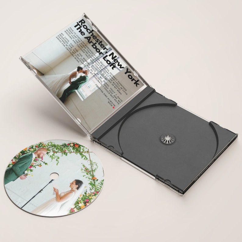 May include: A CD case with a black disc and a clear plastic cover. The cover features a photo of a wedding ceremony with the text "Rochester, New York The Arbor Loft" and a list of song titles.
