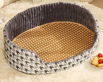 May include: A gray and white houndstooth patterned dog bed with a gray plush rim and a woven bamboo mat insert.