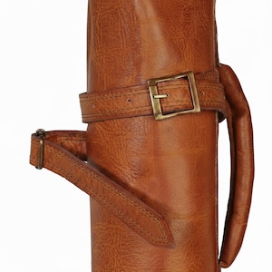 Golf bag showing strap to tighten the bag.One of the 8 colors available of vintage leather buffalo hide leather golf bag. Handmade personalized golf gift for golfer. A great retirement gift, christmas gift ideas for him, gift for him. Vintage tan leather golf bag made of real leather with golf clubs inside the bag. golf bag have 2 pockets and brass accessories. engraving option is also available for this golf bag.