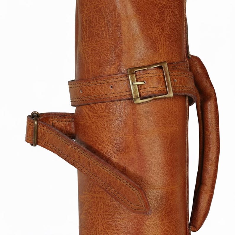 Golf bag showing strap to tighten the bag.One of the 8 colors available of vintage leather buffalo hide leather golf bag. Handmade personalized golf gift for golfer. A great retirement gift, christmas gift ideas for him, gift for him. Vintage tan leather golf bag made of real leather with golf clubs inside the bag. golf bag have 2 pockets and brass accessories. engraving option is also available for this golf bag.