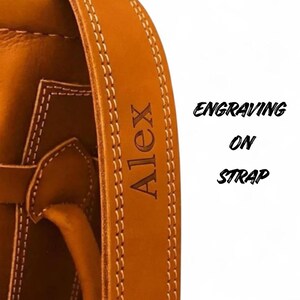 Engraving on the strap of leather golf bag with personalization option.One of the 8 colors available of vintage leather buffalo hide leather golf bag. Handmade personalized golf gift for golfer. A great retirement gift, christmas gift ideas for him, gift for him. Vintage tan leather golf bag made of real leather with golf clubs inside the bag. golf bag have 2 pockets and brass accessories. engraving option is also available for this golf bag.