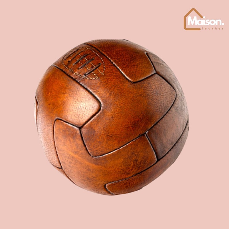 May include: A brown leather soccer ball with a classic design. The ball is made of stitched panels and has a worn, vintage look.