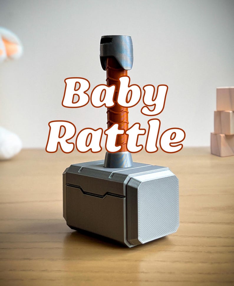 3D printed Thor hammer baby rattle with custom name engraving and multiple handle colors including black, brown, light blue, pink, and yellow. This personalized baby rattle is a unique custom baby gift perfect for little superheroes and Marvel fans.