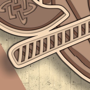 Peut inclure: Une d&eacute;coupe en papier de couleur beige et marron repr&eacute;sentant une &eacute;p&eacute;e avec un motif de n&oelig;ud celtique sur la poign&eacute;e.