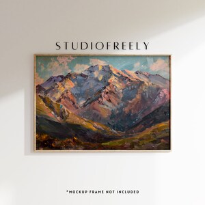 May include: A framed painting depicting a mountain range with a blue sky and white clouds. The mountains are painted in shades of brown, pink, and green. The painting is in a wooden frame.