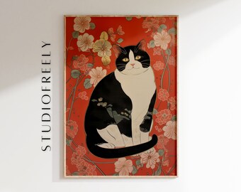 Op de afbeelding: Een ingelijste kunstdruk met een zwart-witte kat met gele ogen, tegen een rode achtergrond met bloemmotieven. Het kunstwerk heeft een vintage esthetiek, met de tekst "STUDIOFREELY" aan de linkerkant.