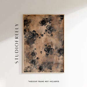 May include: A framed print with a black and white floral pattern on a brown background. The print is in a wooden frame.